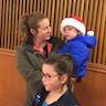 Photo of a young Santa enjoying Christmas carols