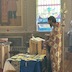 Fr. Vjekoslav, facing to the left of frame, is blessing new, blue vestments that are on a table in front of him.