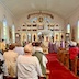 View from the back of the church during our lenten_mission. The church is mostly full, and four clergy members wearing purple vestments can be seen near the front of the church.