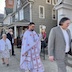 Fr. Aleksey and parishoners as part of a procession. They are currently walking past the entrance to the church.