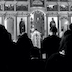 Black and white photo similar to the previous photo but taken from the back of the church with the backs of the congregation in the lower half of the photo.