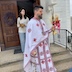 Fr. Aleksey appears in the center of the frame. He has reached the bottom of the (three!) steps, and he's facing the right side of the frame as he walks in that direction. There's a young woman behind him at the tops of the steps, and she's holding a gold bowl filled with holy water.